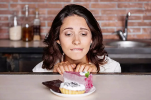 woman looking a cakes craving sugar